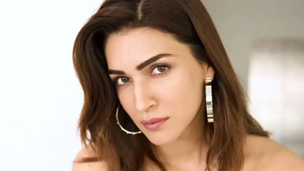 Kriti Sanon performing a stability ball workout while hanging from an overhead bar